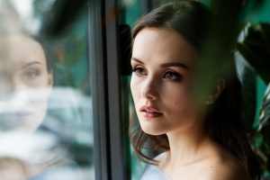 woman and her reflection in a window